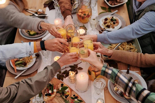 people making a toast across a table