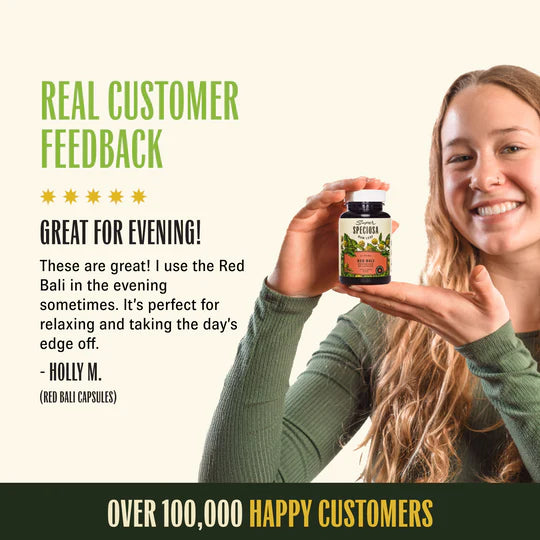 smiling woman holding red bali capsules