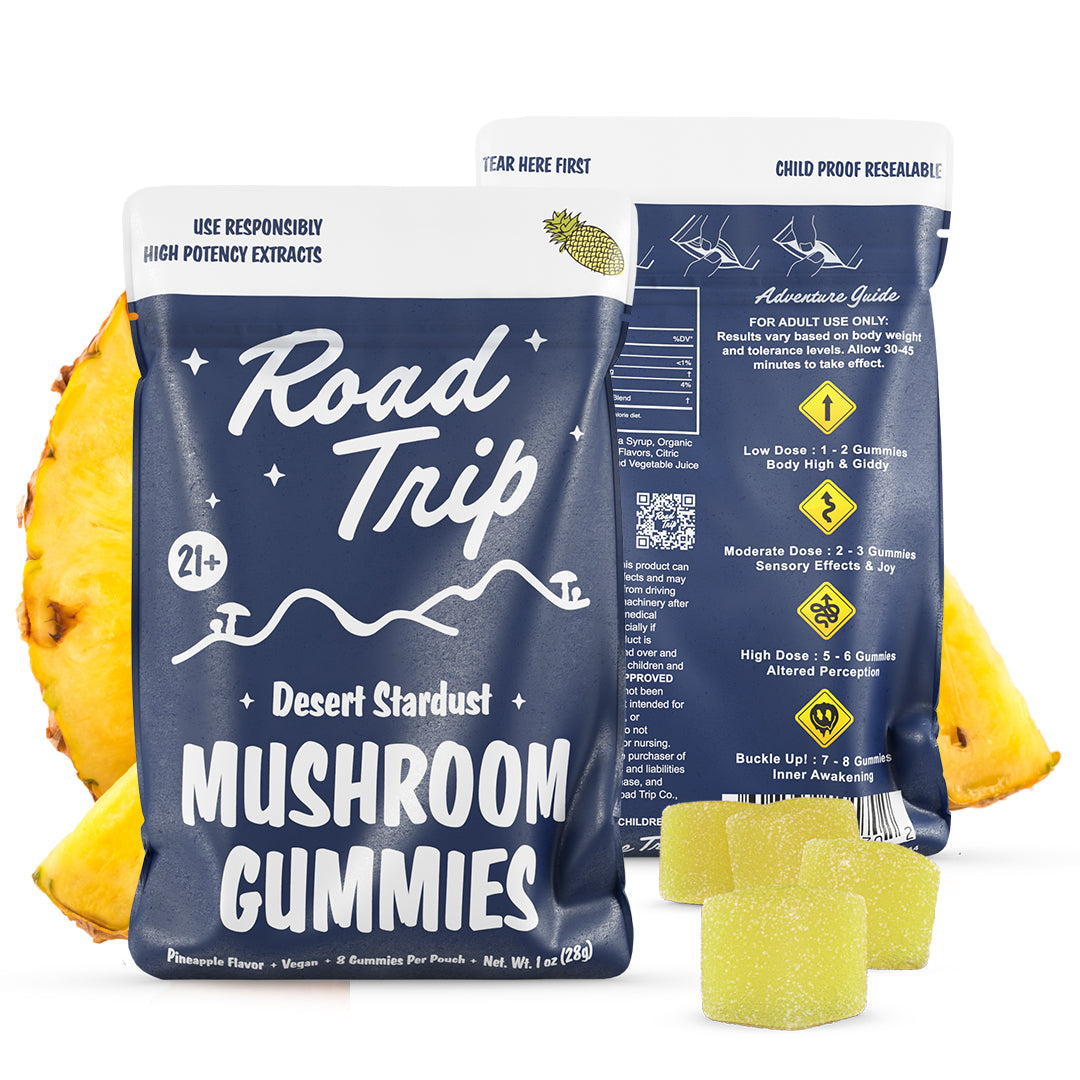 Road Trip Desert Stardust Magic Mushroom Gummies, magic mushroom gummies, mushroom gummies, mushroom extracts, blue bag with white text and mushrooms and mountains with pineapple slices and yellow square gummies, pineapple