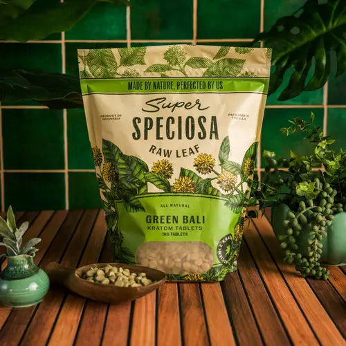 super speciosa green bali kratom tablets with leafy background