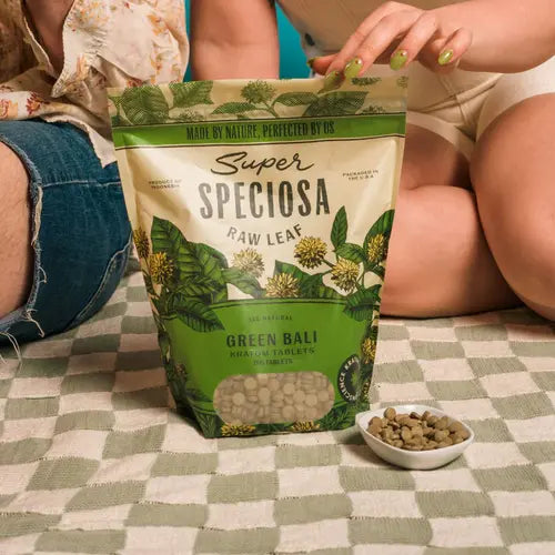 super speciosa green bali tablets in front of people sitting on floor