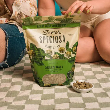 super speciosa green bali tablets in front of people sitting on floor