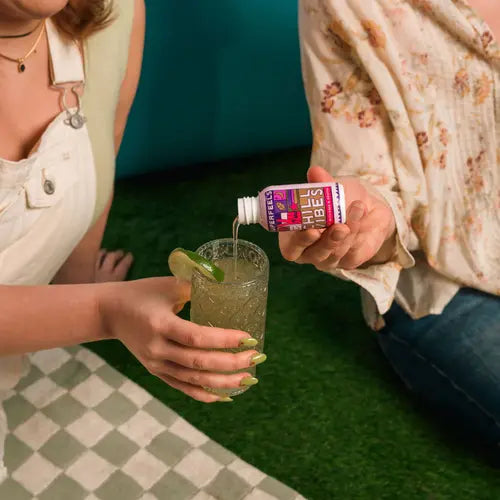 hands pouring chill vibes tonic into drink