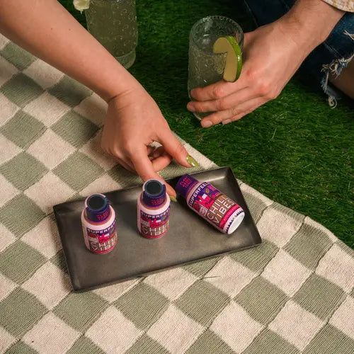 hands reaching for tray of super feels tonic