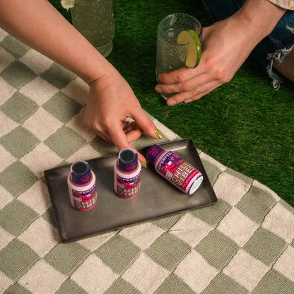 hands reaching for tray of super feels tonic