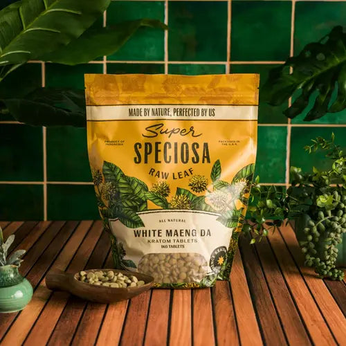 white maeng da tablets - 1 kilogram bag against green tiled background