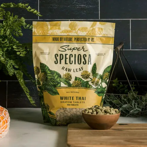 super speciosa white thai kratom tablets 1 kg bag against tiled background